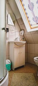 a bathroom with a sink and a mirror at Pokoje Pod Cyrlicą u Józi in Chochołów +81 photos