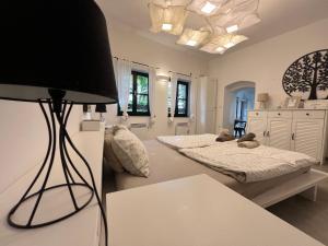 a living room with two beds and a lamp at City Center Deluxe in Kranj