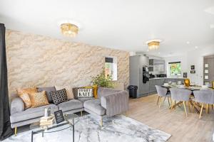 a living room with a couch and a kitchen at Mystic Heights- Wyndale Signature Stays in Worcester