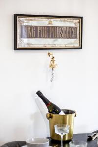 a picture of a bottle of champagne in a bucket at Mystic Heights- Wyndale Signature Stays in Worcester +63 photos