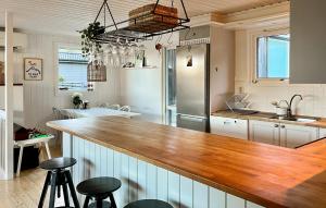 a kitchen with a wooden counter top in a room at Cozy Home In Bjönni With Sauna in Ellös