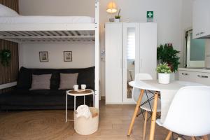a living room with a bed and a table at Lætitia Cottage Apartment in Aversa +15 photos