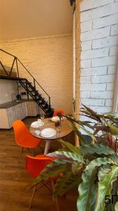 a table and chairs in a room with a staircase at Квартира-студія в центрі міста біля Кобилянської in Chernivtsi +18 photos