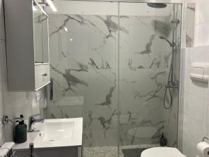 a bathroom with a shower and a sink and a mirror at Casa BELLOCCHIO in Perugia +9 photos