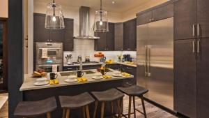 a kitchen with a counter with stools in it at Poma Lodge North in Steamboat Springs