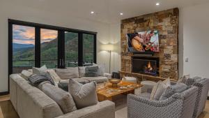 a living room with a couch and a fireplace at Radiance Retreat in Vail