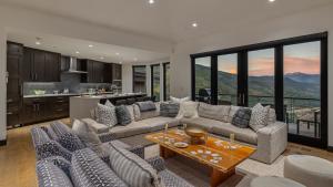 a living room with couches and a table and a kitchen at Radiance Retreat in Vail