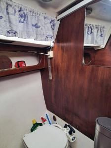 a small bathroom with a toilet and a sink at Romantic getaway on a sailboat in the Tagus in Lisbon