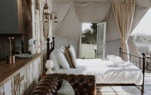 a bedroom with a bed and a large window at Star Gazing Dome 3 with Log Burner & Optional Hot tub in Horspath