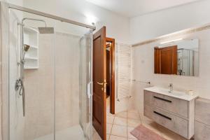 a bathroom with a shower and a sink and a mirror at Mayor's House in Iglesias +18 photos