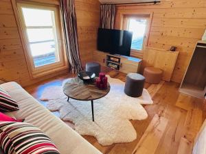 a living room with a couch and a table at The Mazot in Nendaz