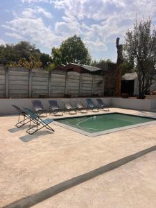 a group of chairs sitting next to a swimming pool at Lanina Garden Unit in Johannesburg