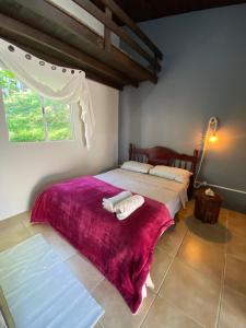 a bedroom with two beds and a window at Casa Reserva Encantada in Garopaba