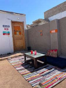 a table with two red cups on a rug next to a door at Mountain view House in Dahab +3 photos