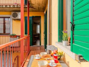 a table on a balcony with a teddy bear on it at Apartment Residenza Elisa by Interhome in Rovellasca