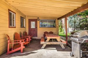 a porch with a picnic table and chairs and a grill at Creekside Juanita's Place - 51 E 200 in Moab