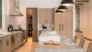 a kitchen with a table with a bowl of fruit on it at Riverlight Lodge in Steamboat Springs