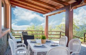 a white table and chairs on a balcony with a view at Country House Chiciabocca in Apecchio