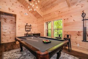 a pool table in a room with wooden walls at Luxury Cabin with Hot Tub, Game Room and Movie Theater in Sevierville +23 photos
