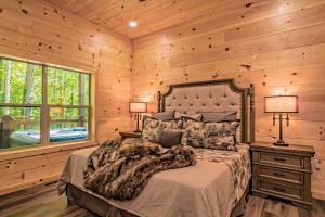a bedroom with a bed and two lamps and a window at Luxury Cabin with Hot Tub, Game Room and Movie Theater in Sevierville