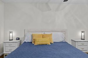 a bed with a blue comforter and two night stands at P Js Inlet - Pet Friendly Oasis in Lavonia