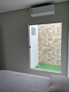 a bedroom with a window and a bed in a room at CF Flat 03 in Petrolina +1 photo