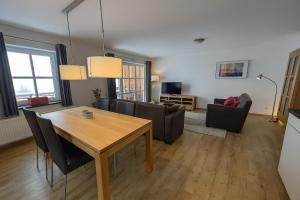 a living room with a dining room table and chairs at Haus Waldblick in Winterberg