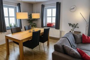 a living room with a table and a couch at Haus Waldblick in Winterberg