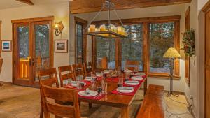 a dining room with a wooden table and chairs at Rustic Timber Lodge in Breckenridge