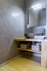 a bathroom with a sink and a mirror at Entre mer et montagne Villa Cartalavonu in Porto-Vecchio