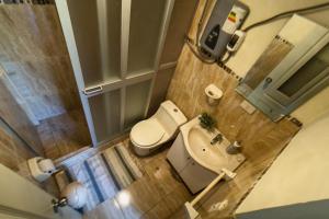 a small bathroom with a toilet and a sink at Pinkuylluna Lodge in Ollantaytambo