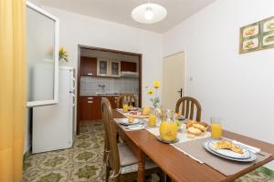 a dining room with a table with food on it at Apartment Nela in Brna +27 photos