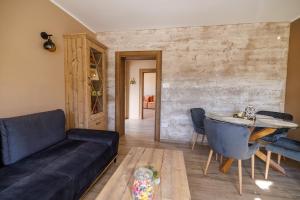 a living room with a couch and a table at Vila Suncokreti Topola in Topola