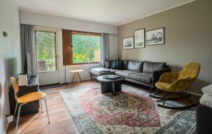 a living room with a couch and a table at Cozy Ranua Koivutie townhouse with sauna & terrace in Ranua +25 photos
