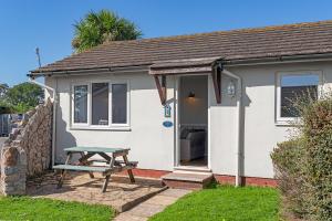 a small house with a picnic table in front of it at No 1 Cottage in Brixham