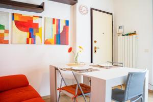 a dining room with a white table and chairs at La casa di Leonardo in Civitanova Marche