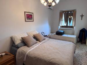 a bedroom with a bed and a cross on the wall at Carell'is house in Ausonia