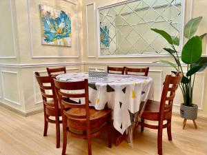 a dining room with a table with chairs and a plant at D Erin Homestay in Banting +2 photos