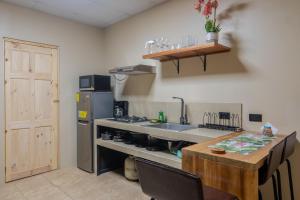 a kitchen with a sink and a refrigerator and a table at Marsol 2 in Bahia +4 photos