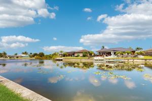 a body of water with houses in the background at Into the Blue in Cape Coral Hospital Heliport