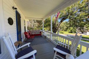 a porch with two chairs and a couch on it at Firefly Cottage in Sky Village