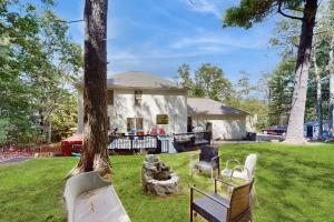 a house with two chairs and a tree at Blue Mountain Crossing in Analomink
