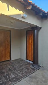 a building with a black pipe next to a door at Akwaaba Fie Guesthouse in Lebowakgomo