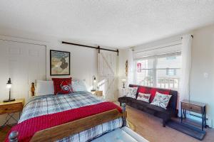 a bedroom with a bed and a couch in it at Sweet Retreat & Dream Weaver in Ludlow
