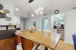 a kitchen and dining room with a wooden table and chairs at Spa On Port Royal Sound 1322 in Hilton Head Island