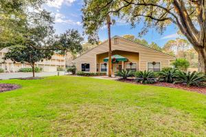 a house with a lawn in front of a building at Spa On Port Royal Sound 1322 in Hilton Head Island