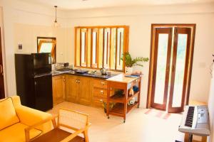a kitchen with a black refrigerator and a table at Spacious view house 2BR in Thôn Châu Chữ