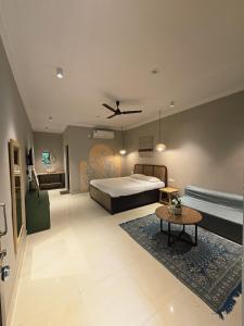 a large bedroom with a bed and a table at The Twelve Palm Resort in Morjim +21 photos