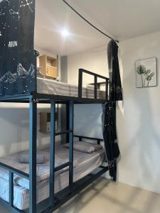 a room with two bunk beds in it at Rest And Relax Hostel in Ban Mo Nae