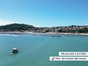a small boat in the water near a beach at Solar Pipa by Pipa Centro in Pipa +61 photos